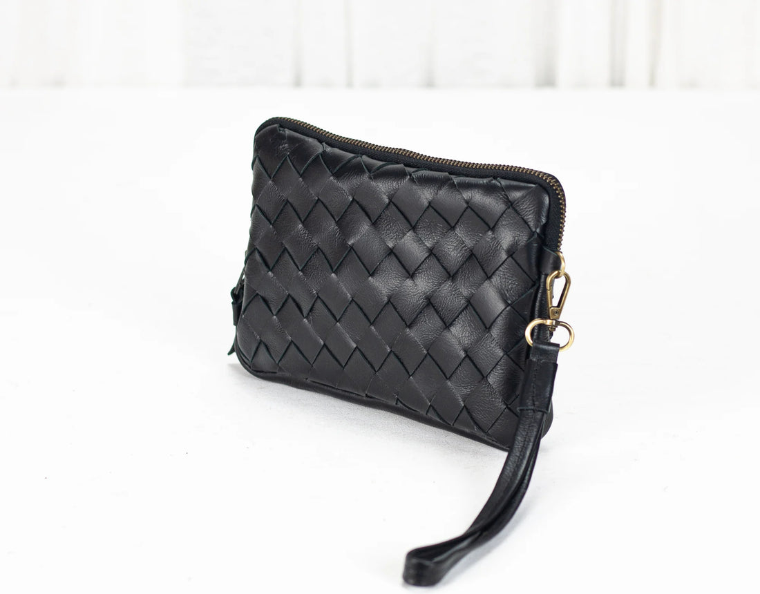 Black woven clutch bag on a white background