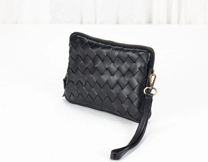 Black woven clutch bag on a white background