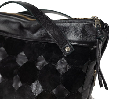 Black textured leather bag with a zipper on a white background