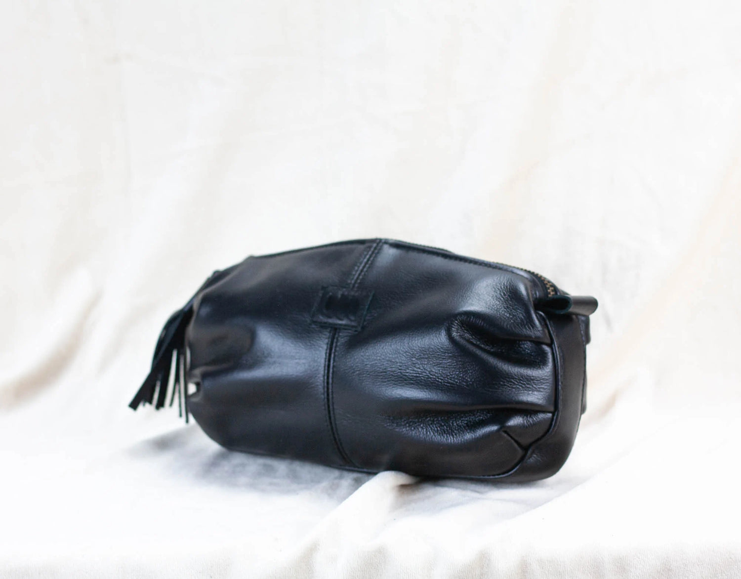 Black leather handbag on a white background