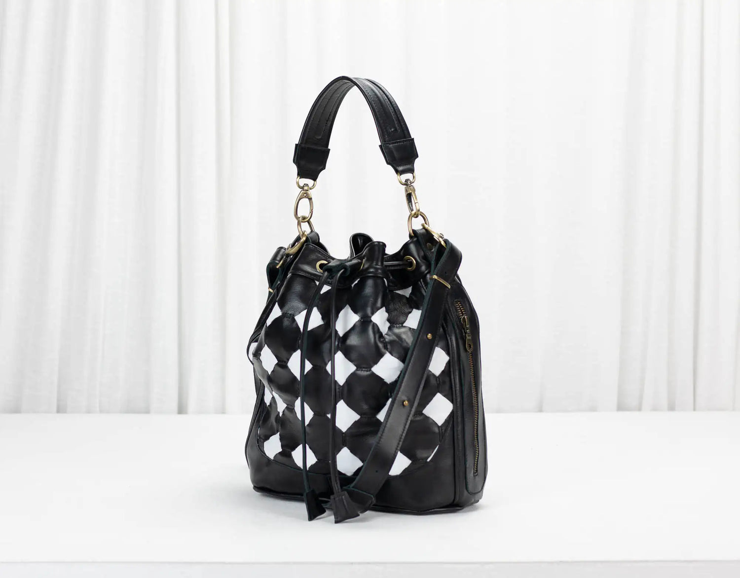 Black and white checkered handbag on a white background