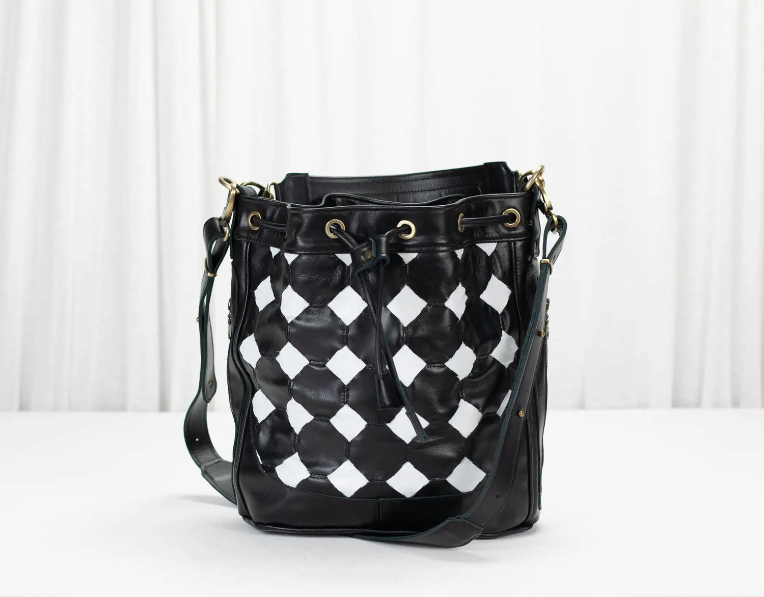Black and white checkered bucket bag on a white background