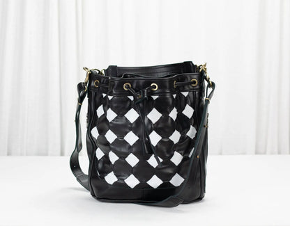 Black and white checkered bucket bag on a white background