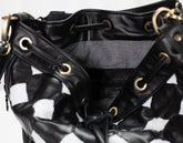 Black leather handbag with gold accents on a white background