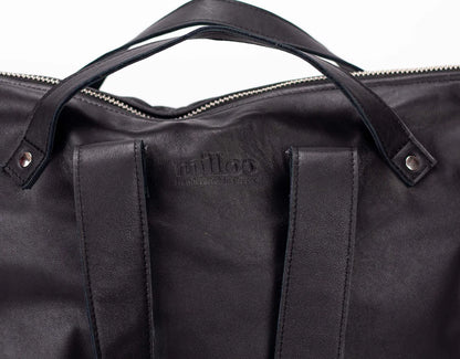 Black leather bag with visible brand logo on a white background