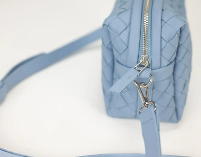 Light blue handbag with a zipper on a white background
