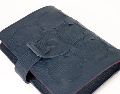 Blue textured wallet with a buckle on a white background