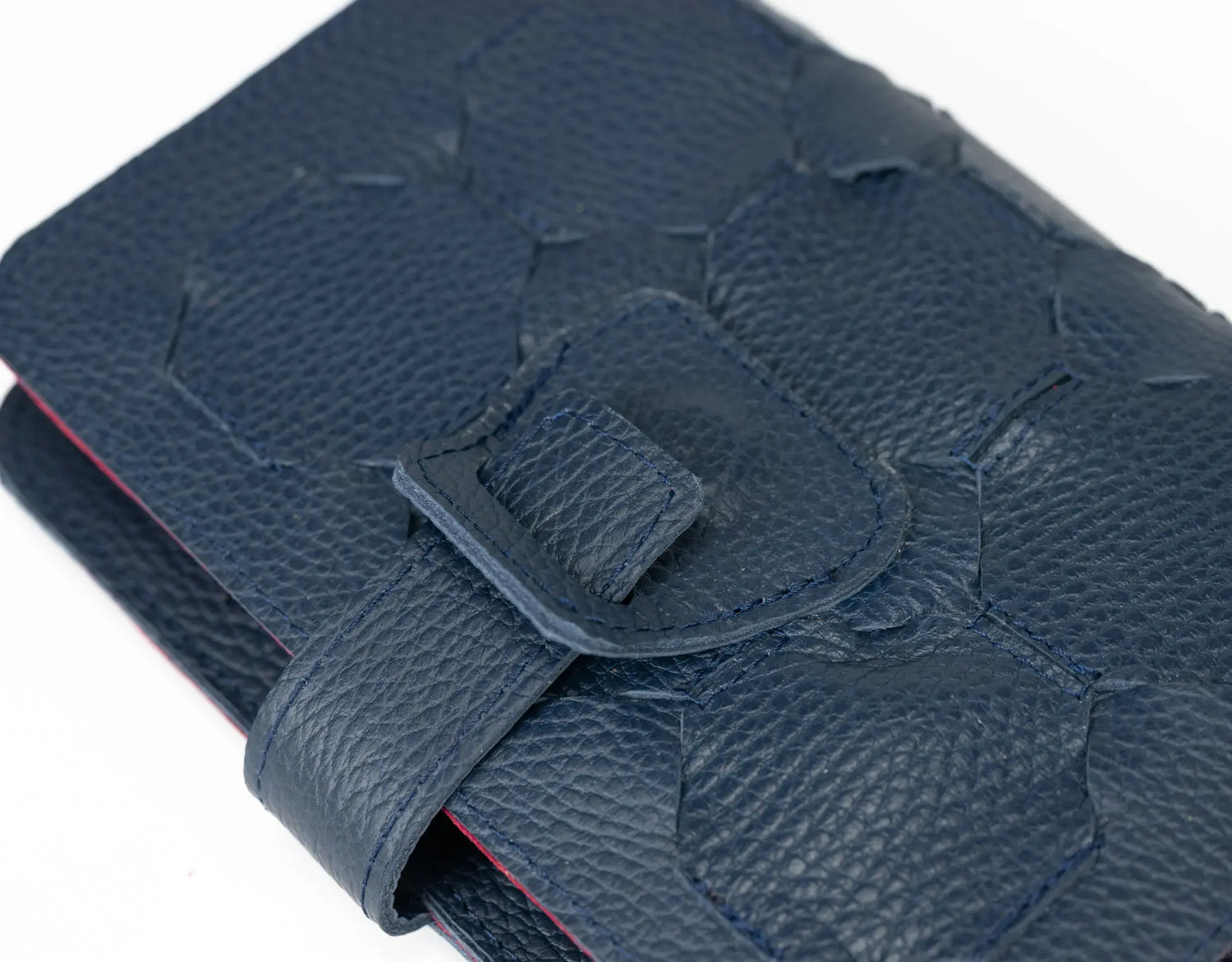 Close-up of a blue textured wallet with a strap on a white background