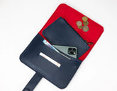 Black wallet with phone and coins on a red pouch