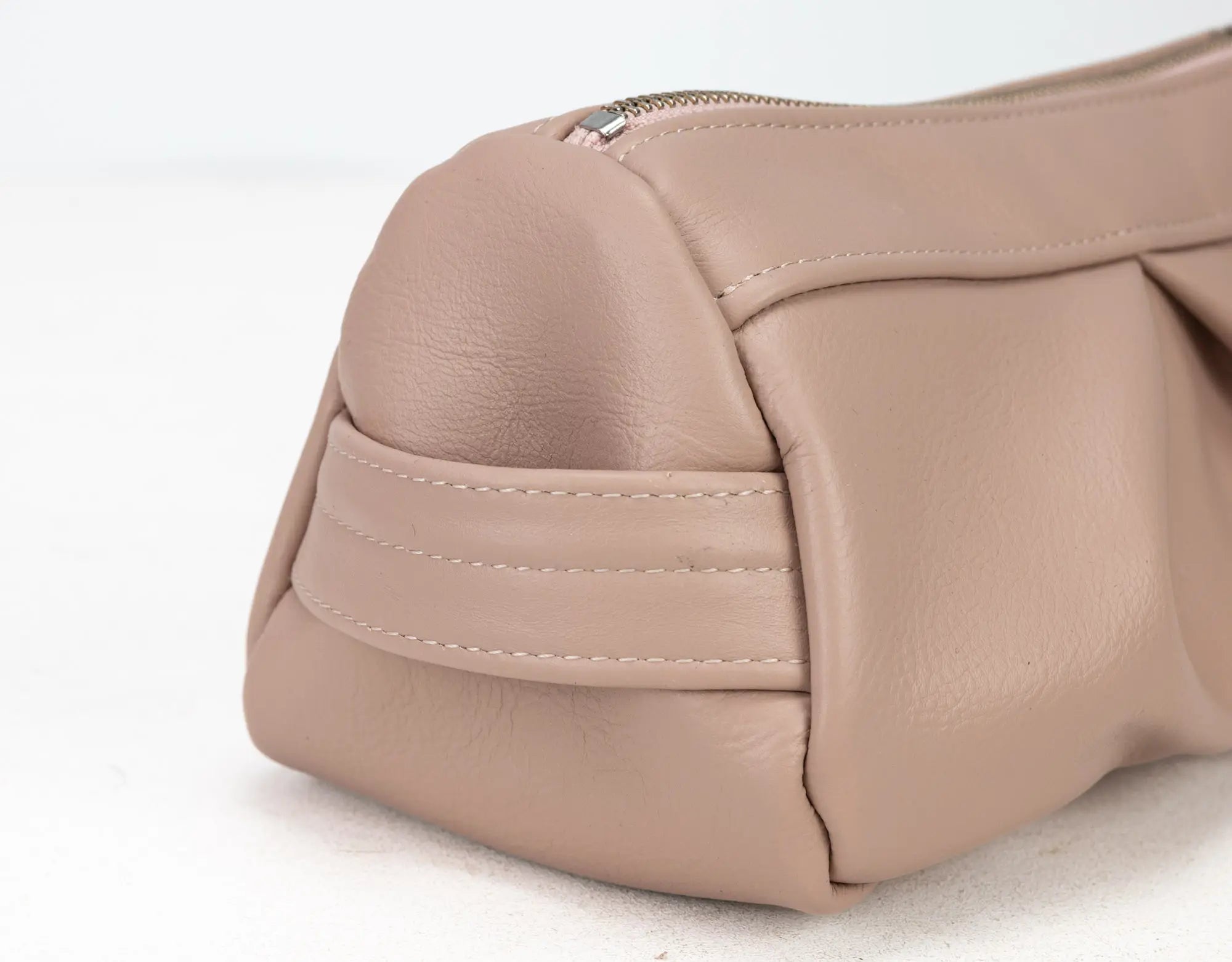 Close-up of a beige handbag on a white background