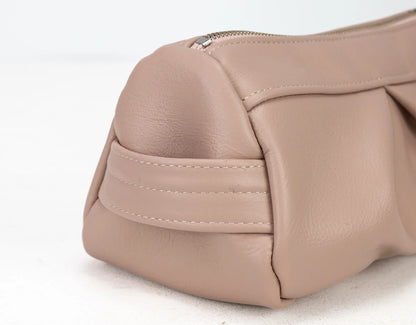 Close-up of a beige handbag on a white background