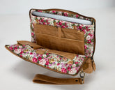 Floral-patterned laptop sleeve with brown leather accents on a white background