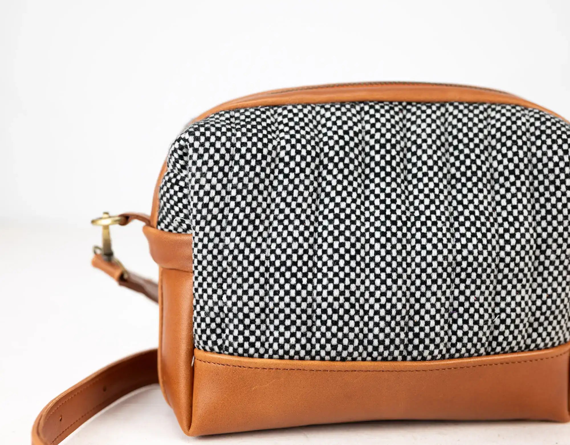 Handbag with black and white patterned top and brown leather sides