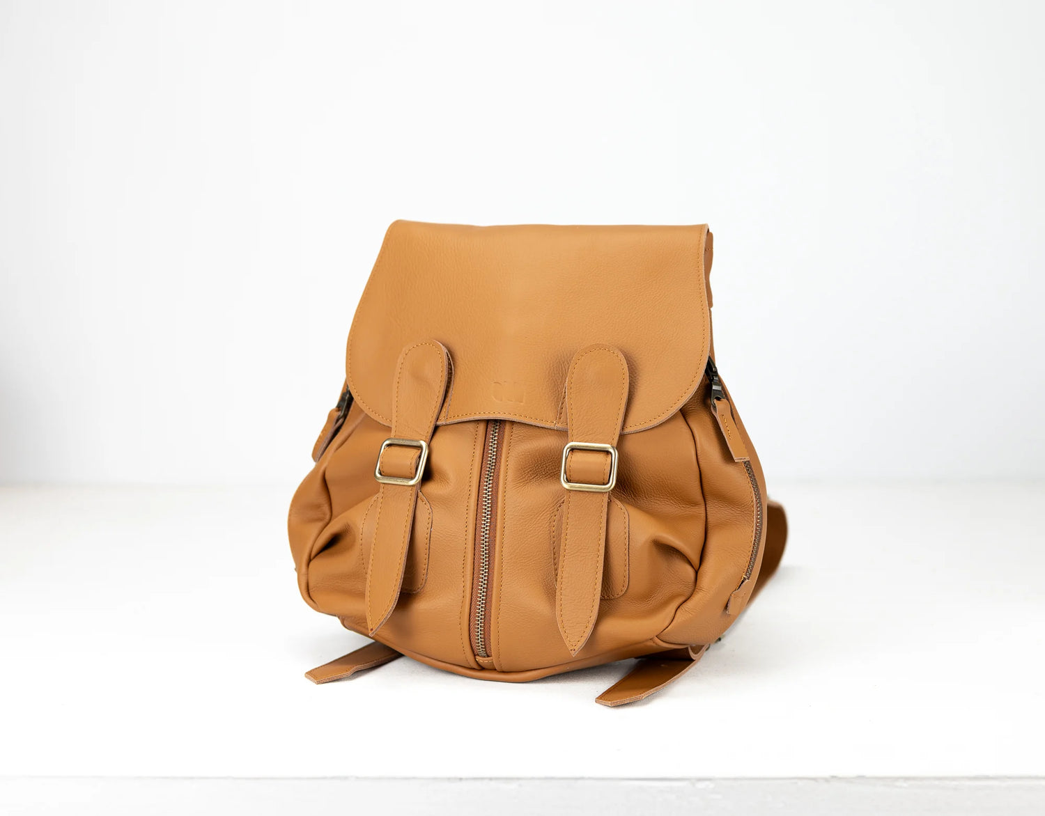 Brown leather backpack on a white background
