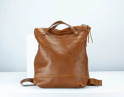 Brown leather backpack on a white background