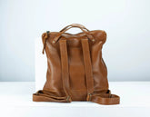 Brown leather backpack on a white background