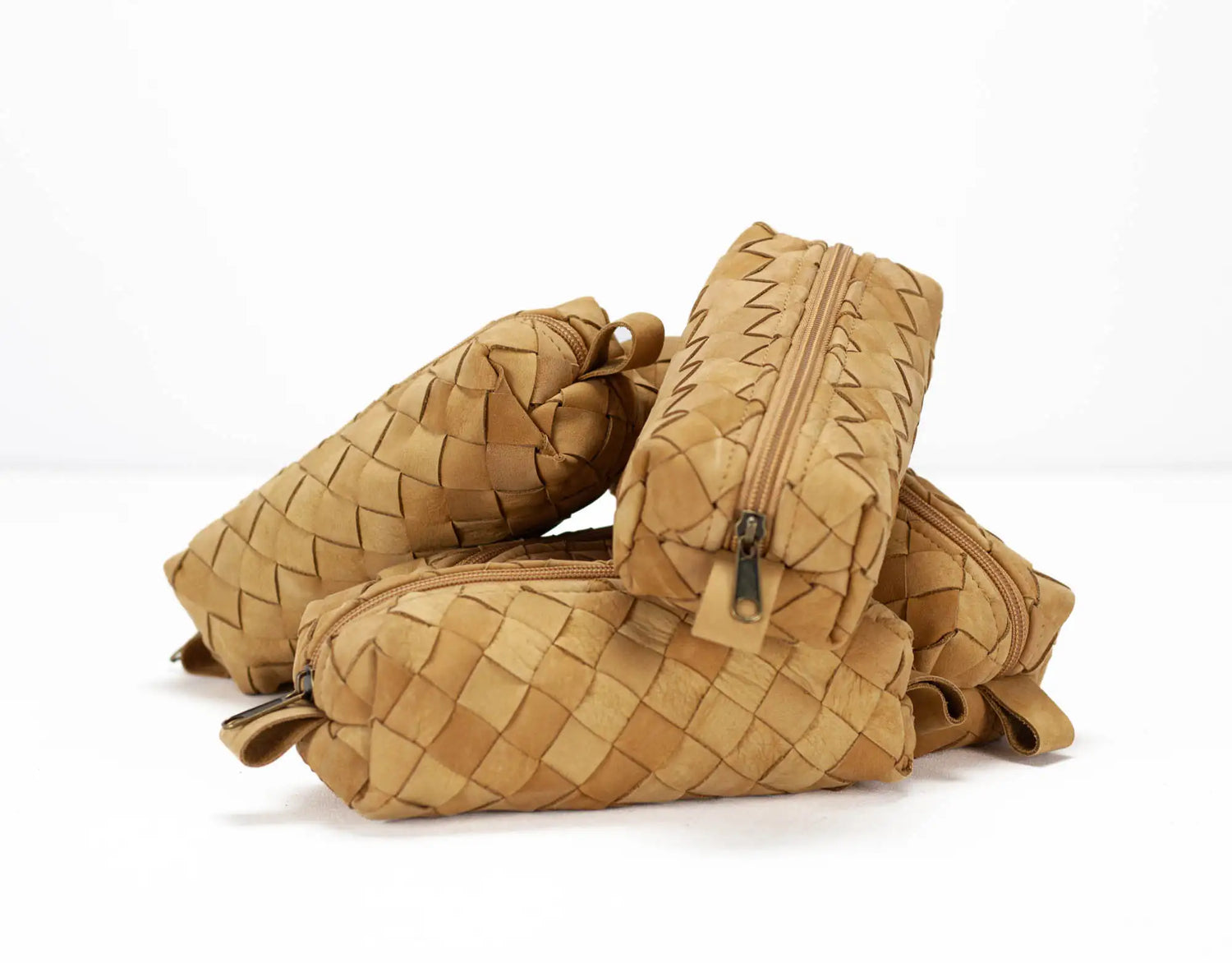 Brown woven leather bag on a white background