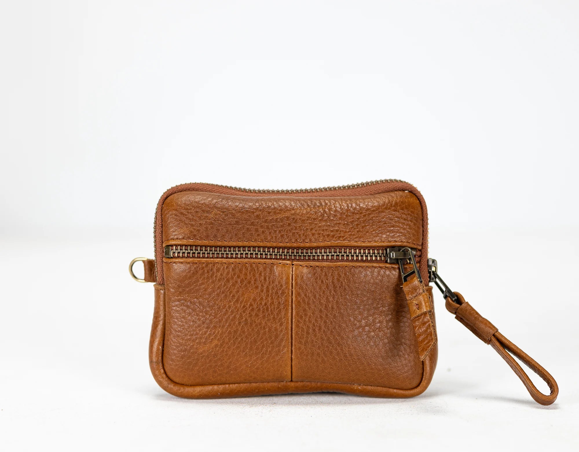 Brown leather wristlet with a zipper on a white background