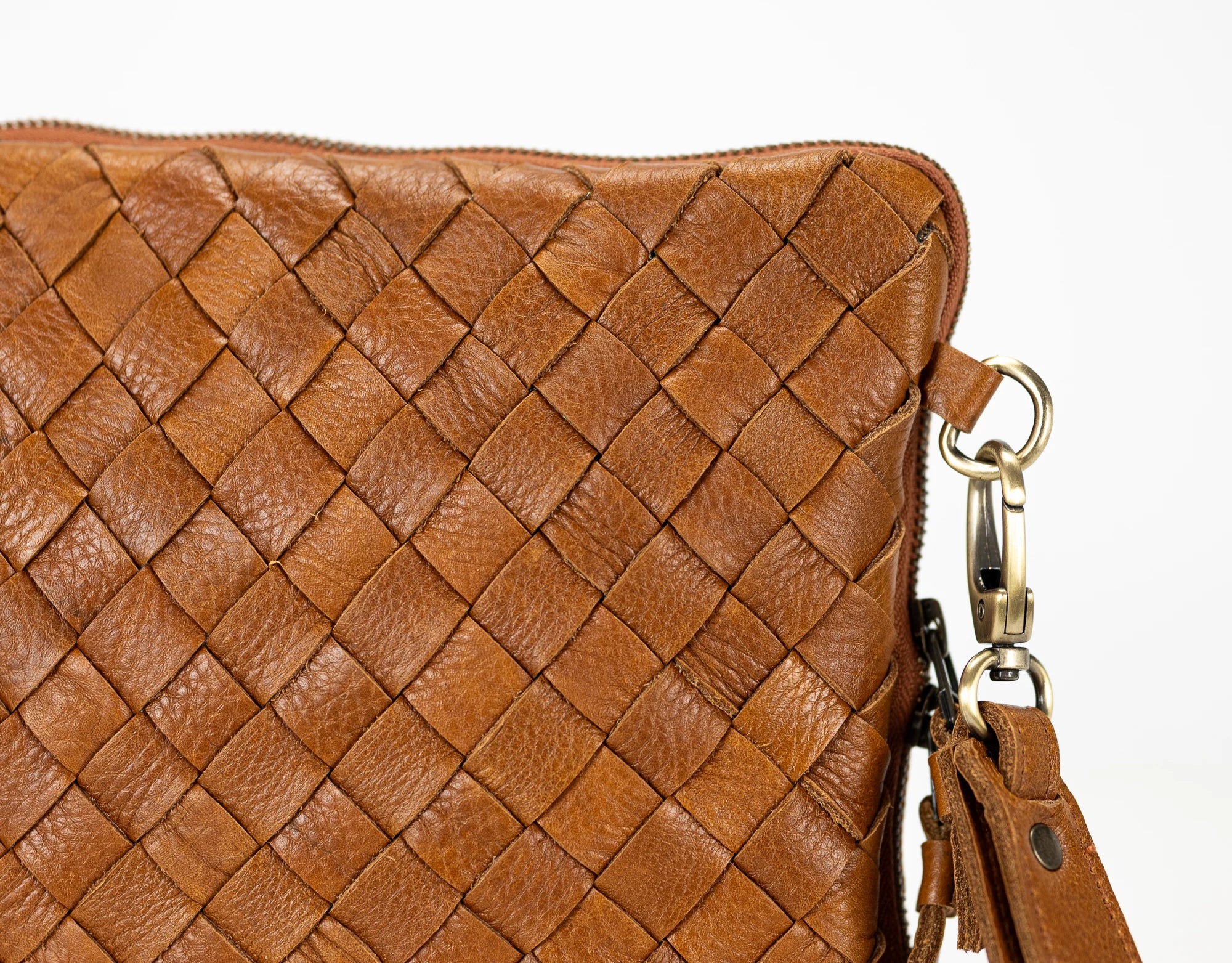 Brown woven leather handbag with a gold clasp on a white background