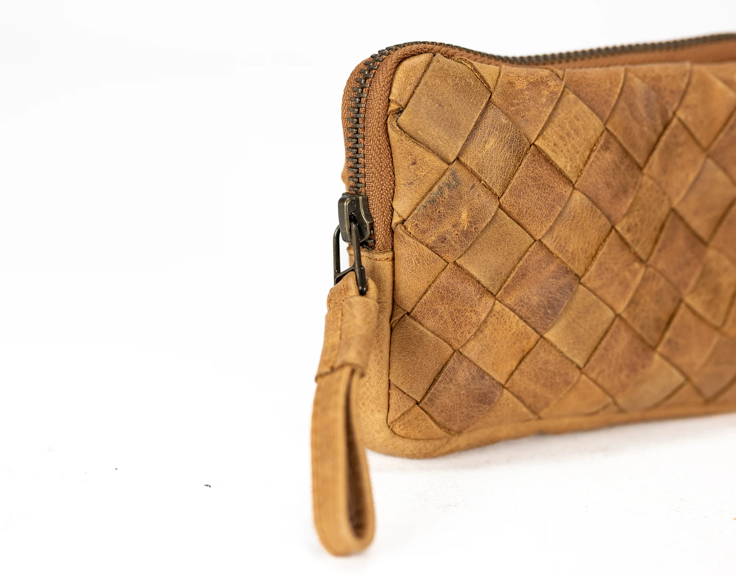 Brown woven leather clutch bag on a white background