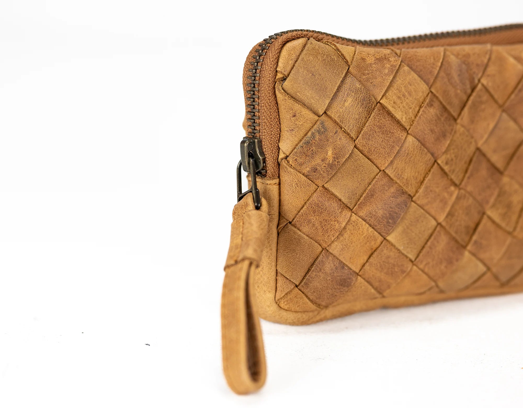 Brown woven leather clutch bag on a white background