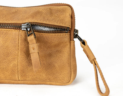 Brown leather clutch bag with a strap on a white background