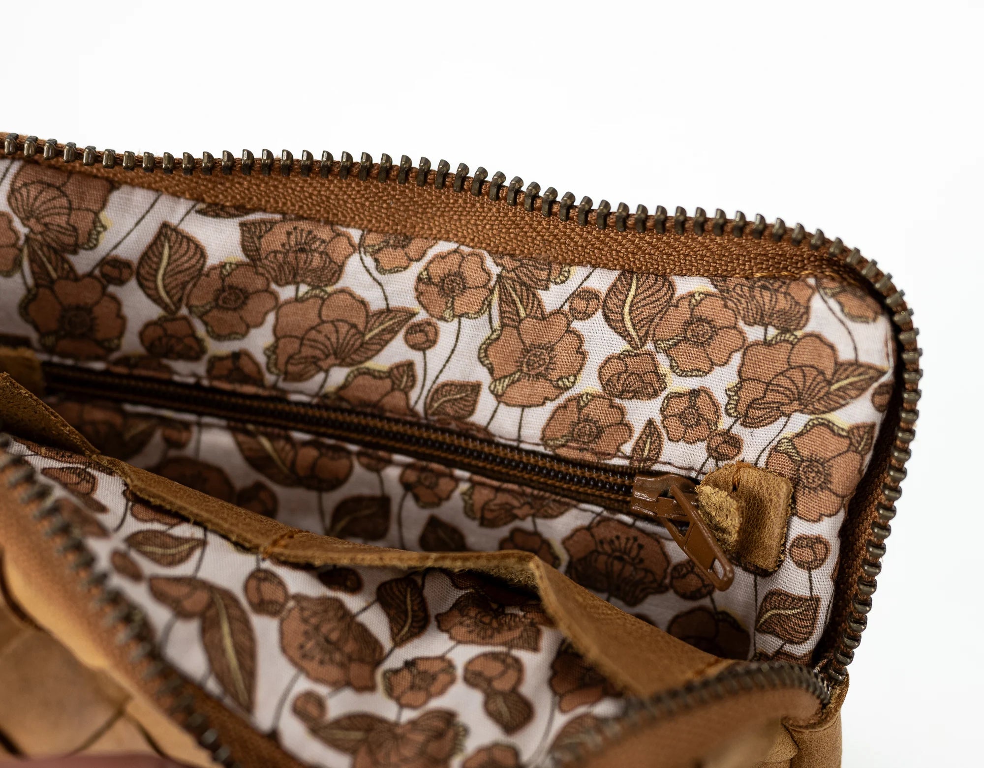 Floral-patterned clutch bag with a zipper on a white background