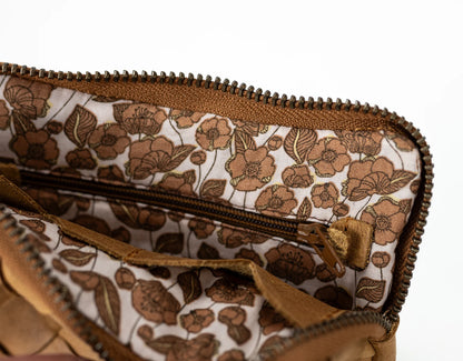 Floral-patterned clutch bag with a zipper on a white background