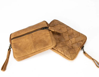Two brown leather bags, one with a zipper and the other woven pattern, on a white background.