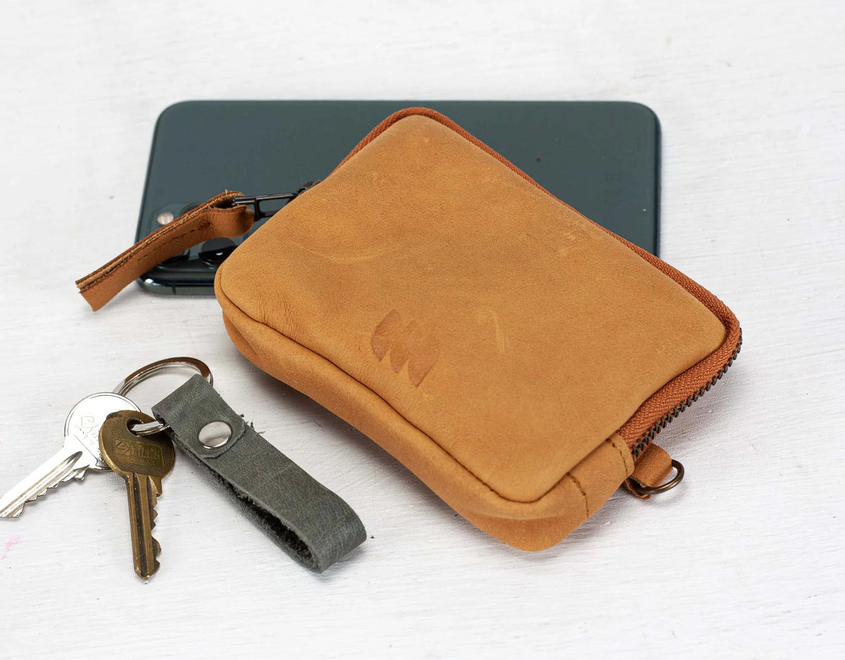 Brown leather pouch with keys on a white background#color_peru-brown