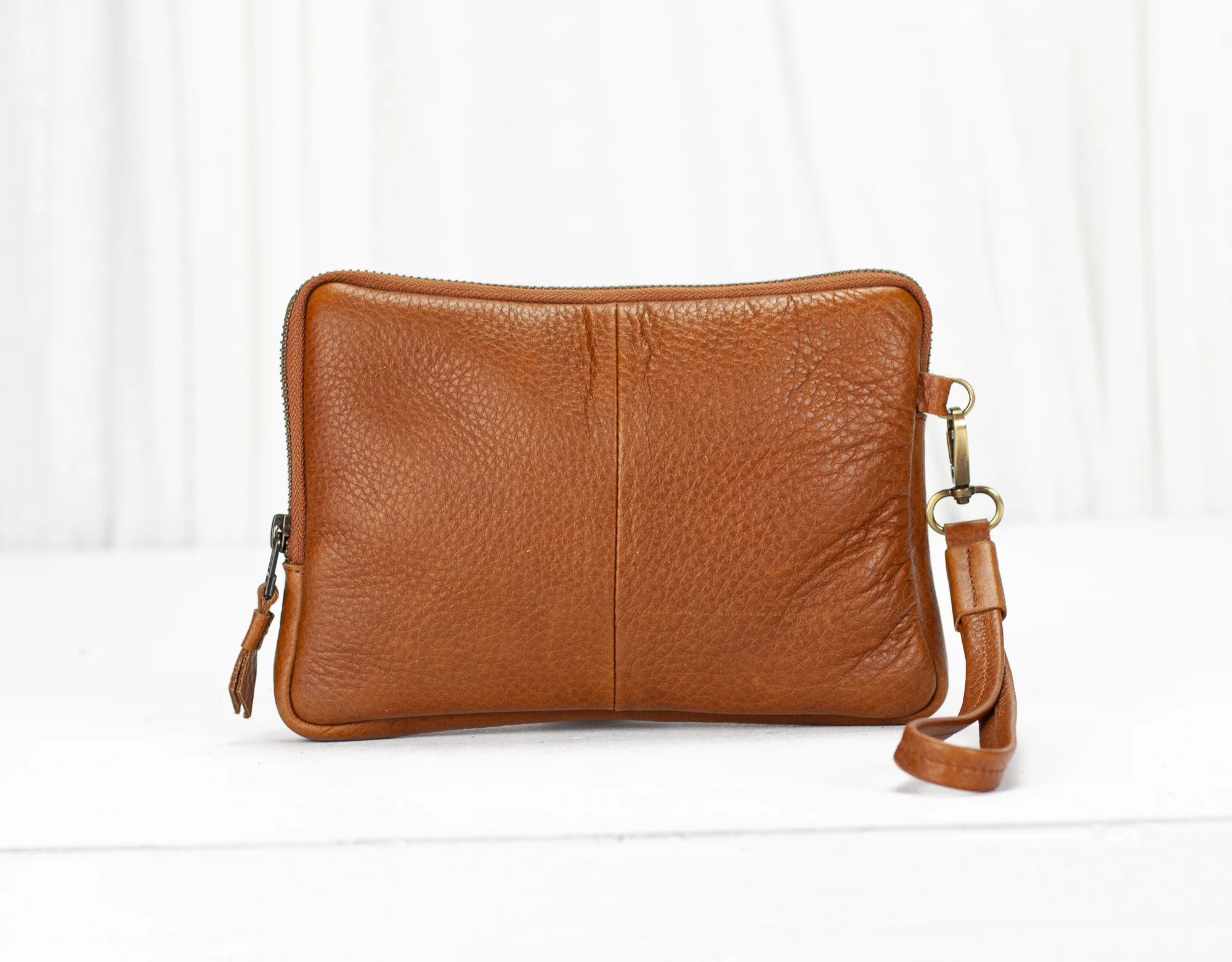 Brown leather crossbody bag on a white background