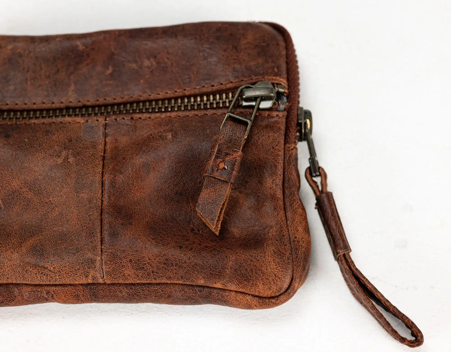 Brown leather wallet with credit cards inside on a white background