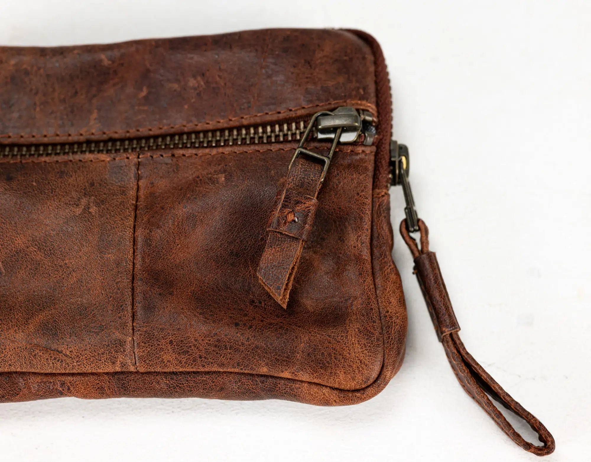 Brown leather wallet with credit cards inside on a white background