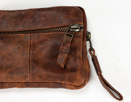 Brown leather wallet with credit cards inside on a white background
