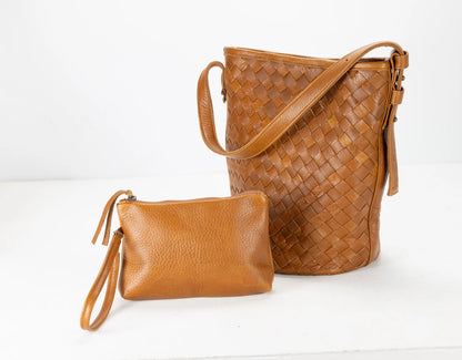 Brown woven handbag and clutch on a white background