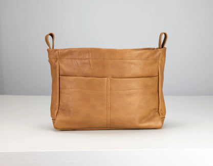 Brown leather bag with handles on a white background