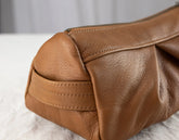 Close-up of a brown leather bag on a light background