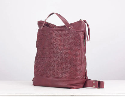 Maroon woven leather bag on a white background
