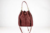 Quilted red handbag on a white background
