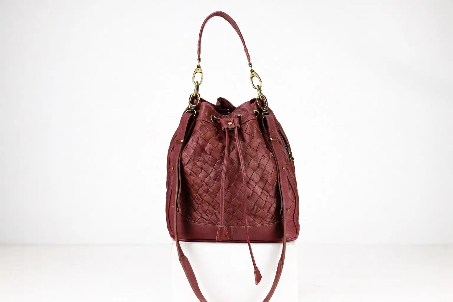 Quilted red handbag on a white background