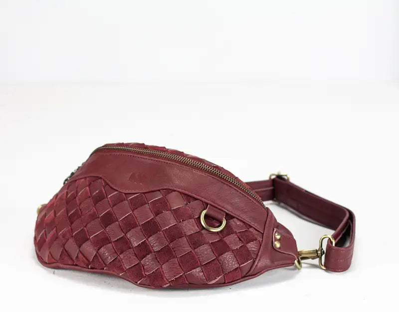 Maroon woven waist bag on a white background
