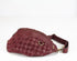 Maroon woven waist bag on a white background