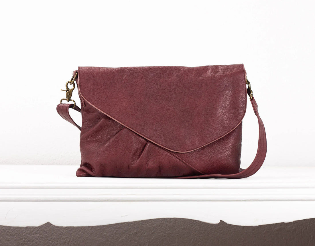 Maroon leather handbag on a white background