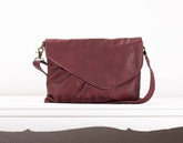 Maroon leather handbag on a white background