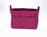 Purple fabric basket with handles on a white background