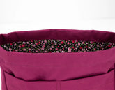Close-up of a purple bag with a floral lining on a white background