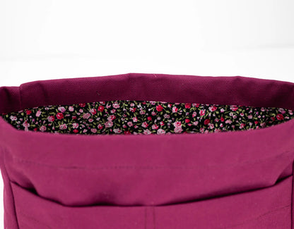 Close-up of a purple bag with a floral lining on a white background