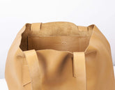 Caramel leather bag with a white background