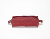 Red leather toiletry bag on a white background