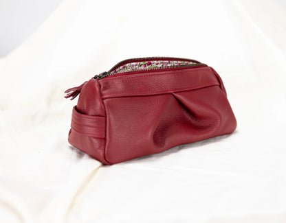 Red leather pouch with a zipper on a white background